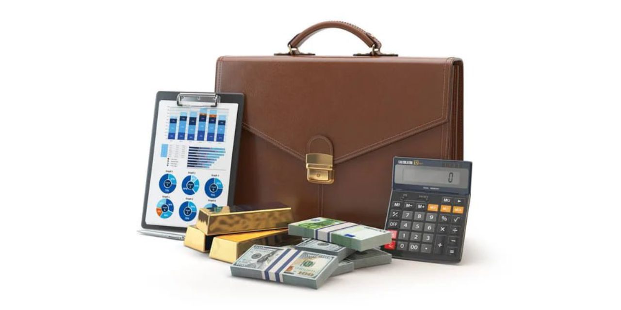 Stock photo with a portfolio, calculator, money, gold bars, and a tablet with charts